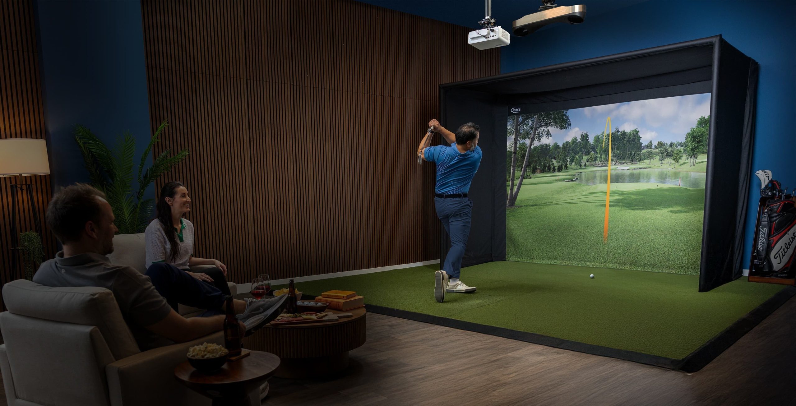 Home golf simulator room with Carl's Place enclosure and projector