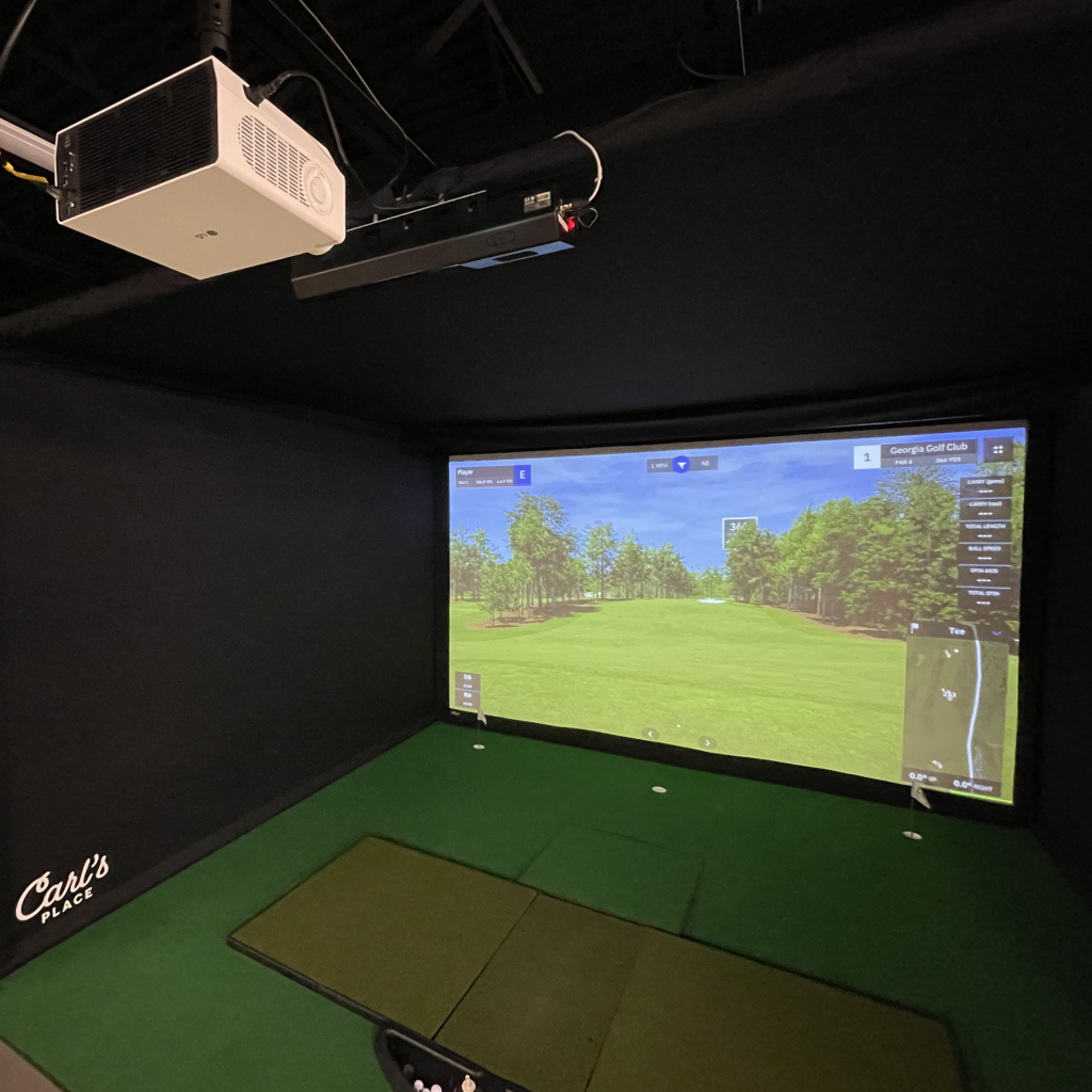 Golf simulator projector and overhead launch monitor above a Carl's Place enclosure