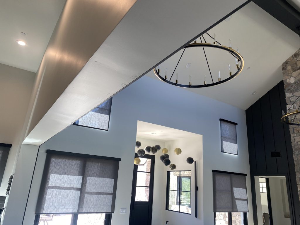 Architectural lighting and automated shades in a contemporary room