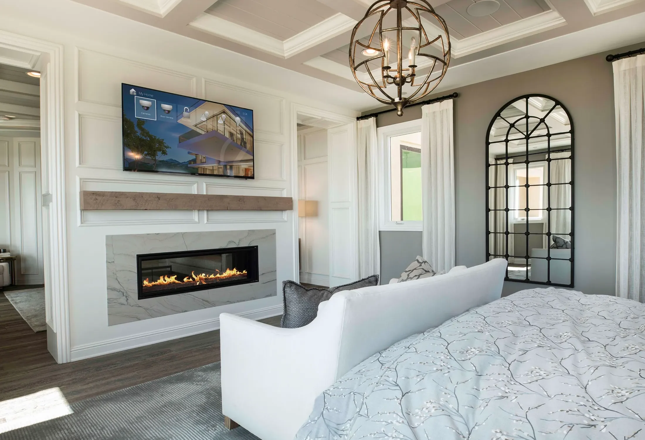 Elegant bedroom with integrated television, fireplace and home control