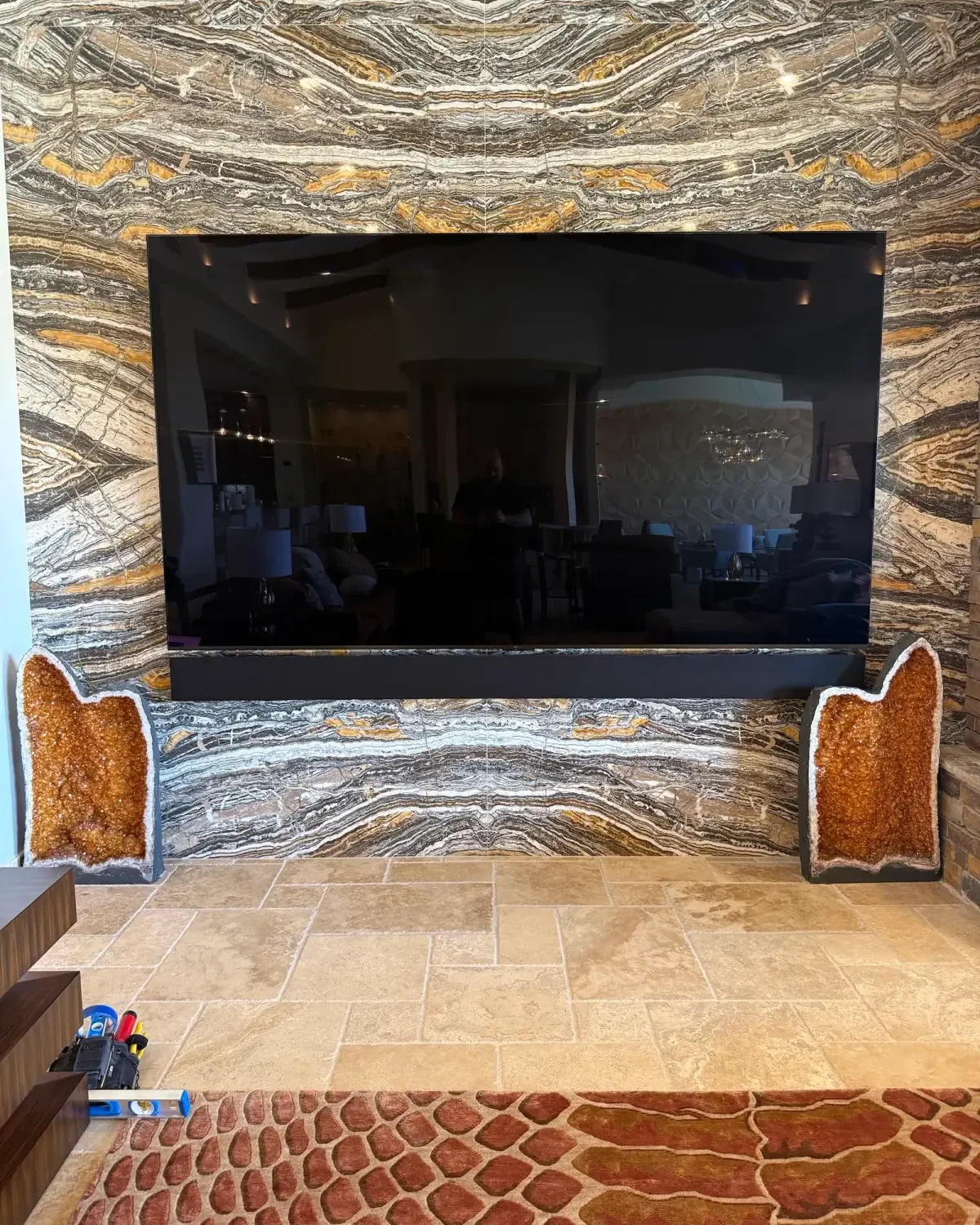 Television integrated into a dramatic stone feature wall