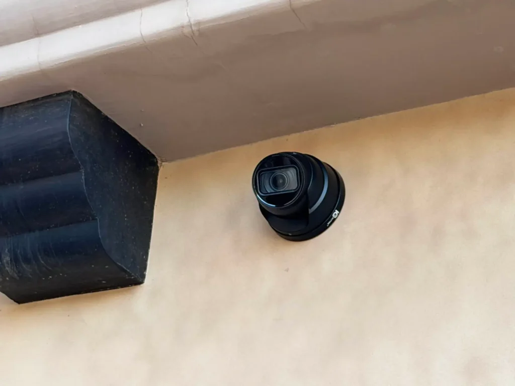 Discreet residential security camera under an exterior eave