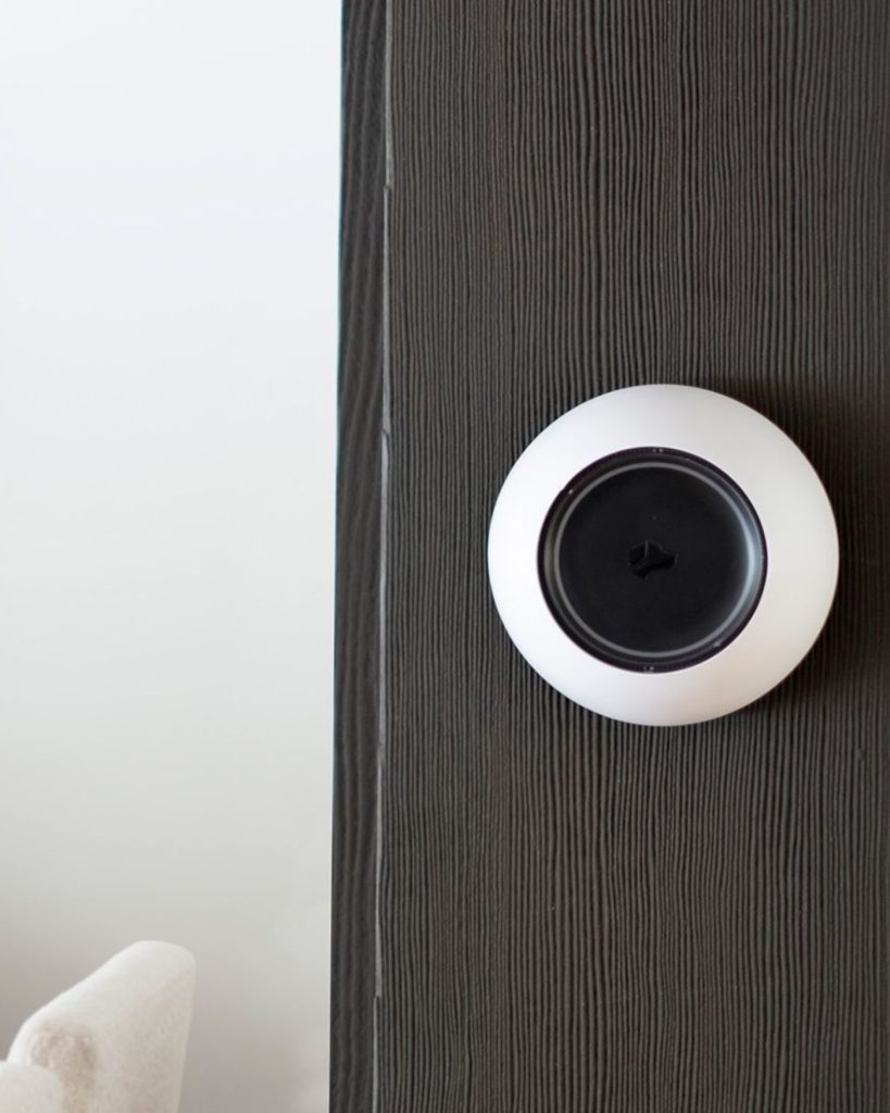 Josh.ai voice-control microphone professionally installed on an architectural wall in a finished living room.